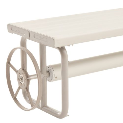 Hidden pool cover roller beneath modern outdoor bench